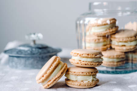 Homemade macarons pastries with custard on the table - close up