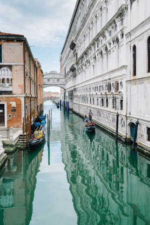 Venice, Italy - May 30, 2020: Gondola with tourists on the canal, in the background the famous bridge of sighs of the Doge's Palaceのeditorial素材