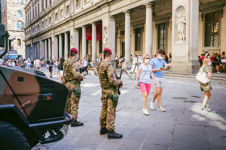 Florence, Italy - August 25, 2020: soldiers on guard in the square of the Uffizi Gallery and tourists walking aroundのeditorial素材