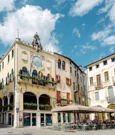 Bassano del Grappa, Italy - May 3, 2021: town hall of the city. Bell tower and astronomical clock located in Piazza LibertÃ  (Freedom square)のeditorial素材