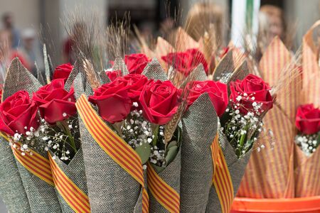 Barcelona, ??Spain_04 / 23/2018: typical bouquet of roses with Catalan flag of saint george dayのeditorial素材