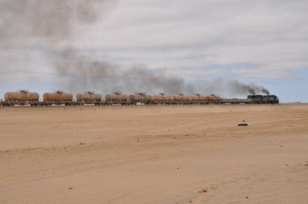 Walvis Bay, Namibia: Cargo locomotive railroad engine crossing Namibia desertの写真素材