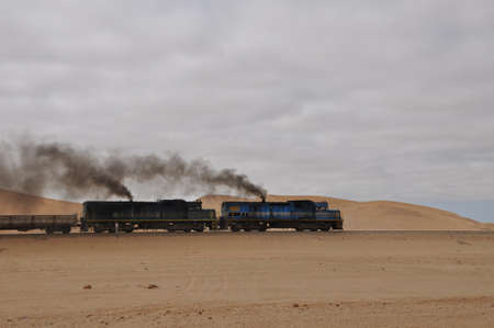 Walvis Bay, Namibia: Cargo locomotive railroad engine crossing Namibia desertのeditorial素材