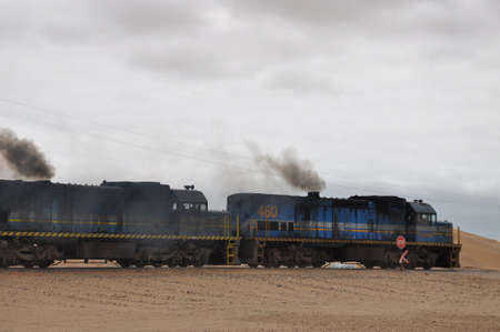 Walvis Bay, Namibia: Cargo locomotive railroad engine crossing Namibia desertのeditorial素材