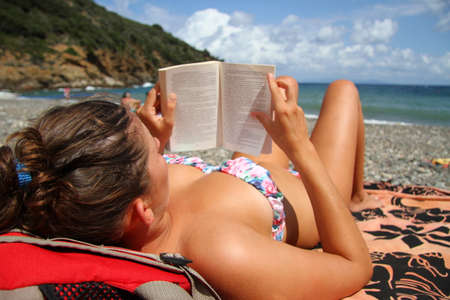 Reading book at the beachの写真素材