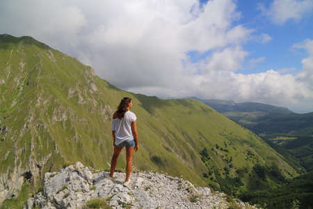 Young lady on the top of a mountainの写真素材