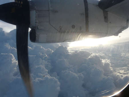 Clouds and sky seen through window of an aircraftの写真素材