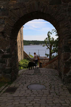 People walking around Ancient Akershus Fortress, Oslo, Norwayのeditorial素材