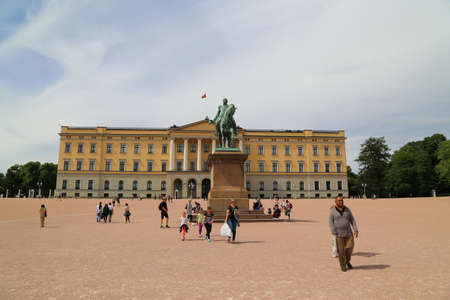 The Royal Palace in Oslo, the capital of Norway. People tourists walking on the palace grounds on a summer dayのeditorial素材