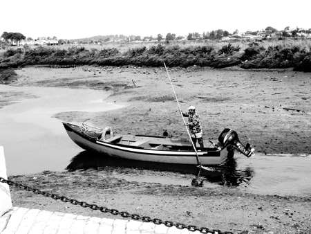 Man nagivates through shallow water.                              の写真素材