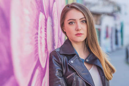 Young woman in urban landscape - graffitiの写真素材