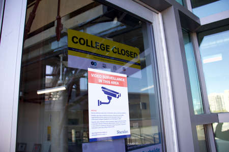 Oakville, Ontario / Canada - September 11, 2020: Sheridan College sign on red brick wall and glass at the Trafalgar Campus, currently closed due to Covid-19 pandemic.のeditorial素材