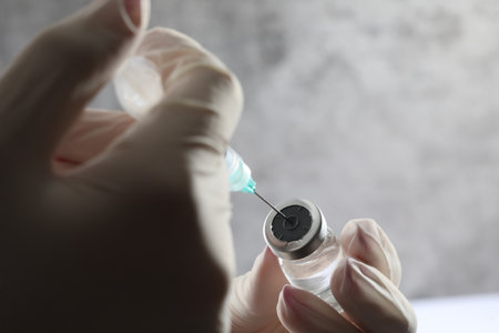 Close-up of a syringe in the hands of a doctor