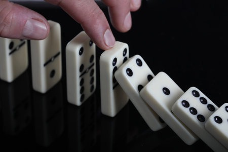 Playing dominoes on a black background. Close-up.