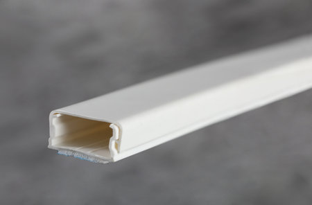 Close-up of a white plastic tube on a gray background.の写真素材