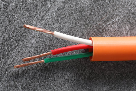 Electrical cable on gray background, closeup. Electricity distribution conceptの写真素材