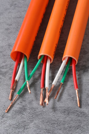 Electrical cable with copper wire on gray background. Closeup.の写真素材