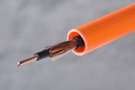 Electric cable with copper wire on a gray background, close-upの写真素材