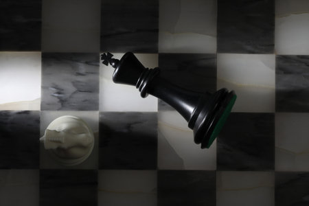 Chess photographed on a chessboard with a chess piece in the foreground