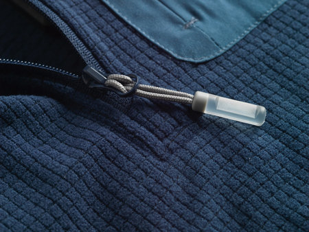 Closeup of a zipper on a blue fleece background. Selective focus.の写真素材