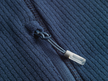 Close up of a zipper on a blue woolen fabric background.の写真素材