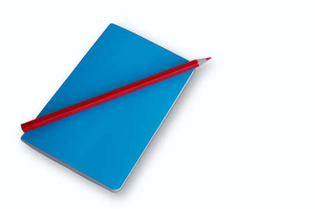 Blue notebook with red pencil on white backgroundの写真素材