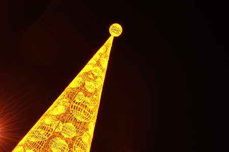 Christmas fir yellow lights on sky backgroundの写真素材