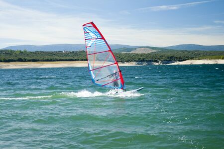 Windsurfing. Recreational water sports during summer vacation. Atazar dam, Madrid, Spainのeditorial素材