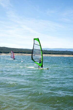 Windsurfing. Recreational water sports during summer vacation. Atazar dam, Madrid, Spainのeditorial素材