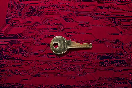 Red electronic board with a key as computer security conceptの写真素材