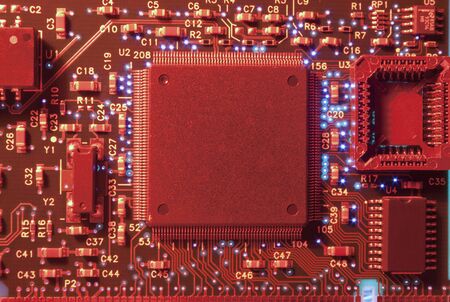 Circuit board close up. Electronic computer hardware technology. In red light.の写真素材