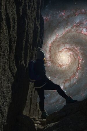 Woman from the back looking towards an enlarged galaxy centerの写真素材