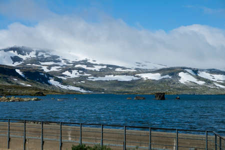 lake landscape with snowcapped mounutains in background, Finse, Norwayの写真素材