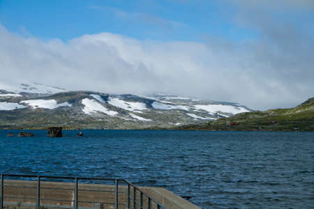lake landscape with snowcapped mounutains in background, Finse, Norwayの写真素材