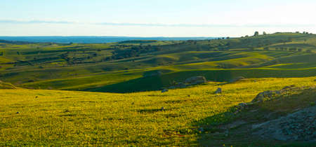 rolling grasslands at sunset, Colmenar Viejo, Madrid, Spainの写真素材