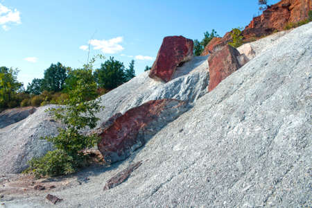 Old kaolin mine under reddish sandstone strata, near the red villages in the spanish province of segoviaの写真素材
