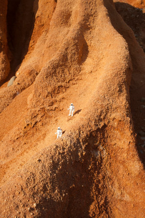 two astronauts exploring valles marineris in mars, concept whith a plastic toyの写真素材