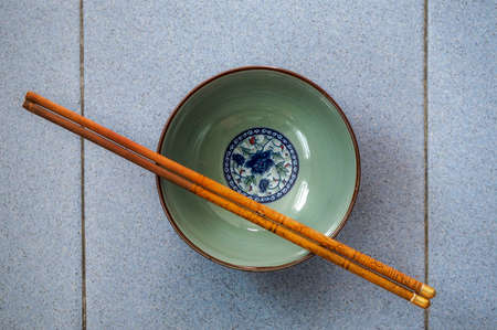 An empty rice bowl with chopsticksの写真素材