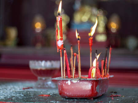 Burning red Chinese candles outside a temple in Penangの写真素材