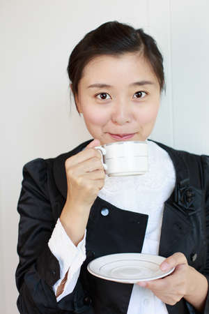 a smiling woman with coffee in handの写真素材