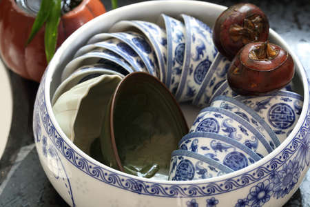 A pot of tea cups and two water chestnutの写真素材