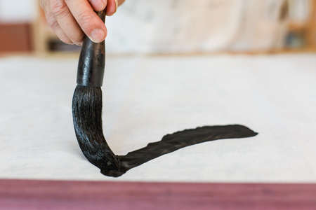 Writing Chinese calligraphy scene, the Chinese character "one"の写真素材
