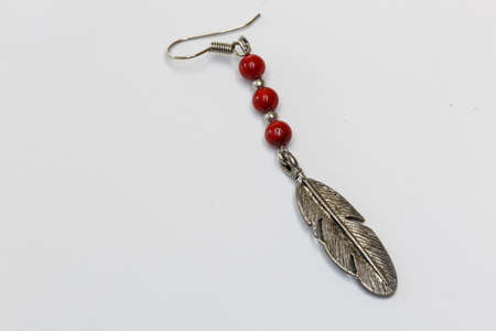 A Feather shape  silver earrings on white background