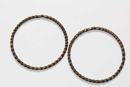 A pair of silver bracelet on a white backgroundの写真素材