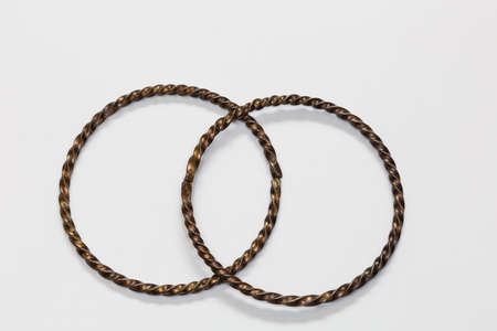A pair of silver bracelet on a white backgroundの写真素材