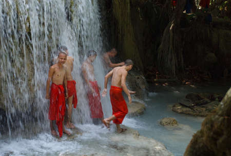 Laos People's Democratic Republic, Luang Prabang - 7 May: A group of young monks were bathing under the falls,splashing ,Luang Prabang, Kansai falls,7 May ,2015のeditorial素材
