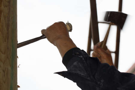 A worker is holding a tool to knock on wood,の写真素材