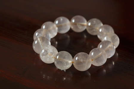 A bunch of pink crystal bracelets on the tableの写真素材