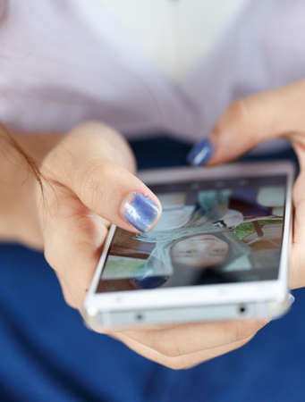 cell phone hold in layd's hand--close up
