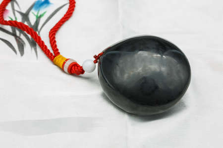 a black South red agate necklace close-up on white backgroundの写真素材